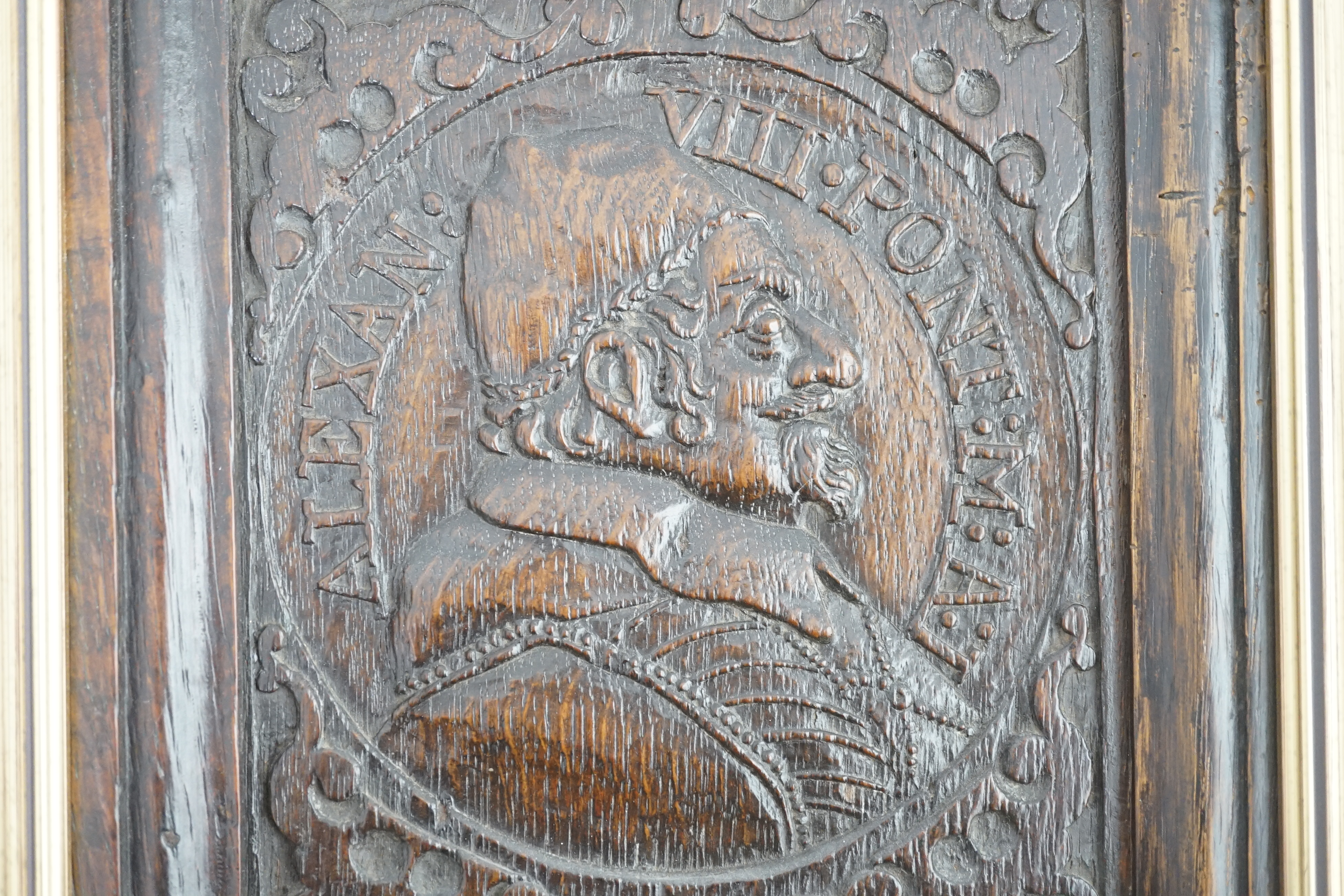 A 17th century oak panel carved with a relief portrait of Pope Alexander VII